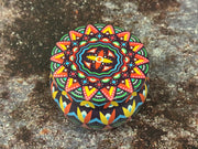 Hand-poured soy wax candle inside decorative Moroccan tin jar